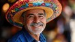 © Creative_Bringer - Man in colorful sombrero, smiling, festive background, warm light