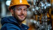 © Evgenii - worker wearing a safety helmet and goggles checks equipment in a manufacturing plant. bright environment reflects the busy atmosphere of industrial operations