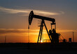© Dostain - A powerful image capturing the silhouette of an oil rig against a vibrant sunset, symbolizing the energy industry, with a visual representation of the oil and gas industry