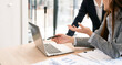 © NAMPIX - Business people Consulting meeting working and brainstorming new business project, using laptop at desk office.