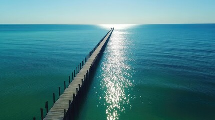 Sticker - Long jetty extending toward the horizon with turquoise waters reflecting sunlight, peaceful seascape