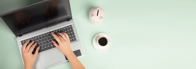 female hands with laptop and coffee cup