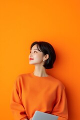 Poster - Vibrant Minimalism South Korean Woman in Orange Sweater Holding Tablet - Modern Corporate Aesthetics and Digital Innovation for Marketing Strategy Development