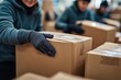 © Solid Tech - Close-up of unrecognizable volunteers packing donation boxes for charity. Generative AI