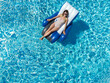 © Oleksandra Bogdan - girl in swimsuit on inflatable chair in pool top view