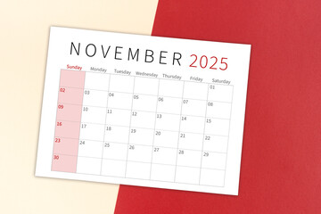 Wall Mural - November 2025 calendar page on yellow and red background.