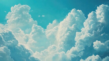 an expansive sky filled with large, billowy cumulus clouds. the clouds are dense and white, contrast