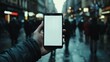 © TensorSpark - A hand holds a smartphone with a blank screen in a busy street, symbolizing mobile connectivity and user interface design.