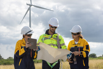 Fototapete - Engineer wearing safety uniform discussed plan about renewable energy at station energy power wind turbine. technology protect environment reduce global warming problems.