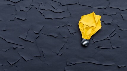 Wall Mural - Yellow Crumpled Paper Lightbulb: A creative concept image featuring a crumpled yellow paper lightbulb on a dark textured background, symbolizing innovative thinking and problem-solving.  