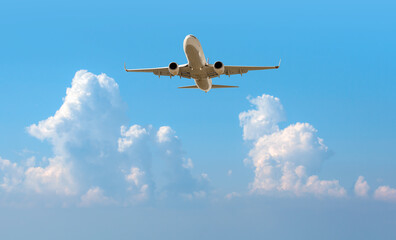 Wall Mural - White passenger airplane flying in the sky amazing clouds in the background - Travel by air transport