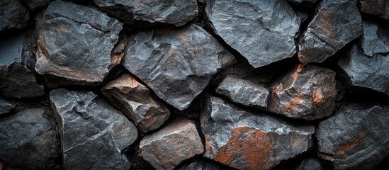 Wall Mural - Textured Black Grunge Rock Wall with Deep Charcoal Background and Ample Copyspace for Text in a Natural Stone Arrangement