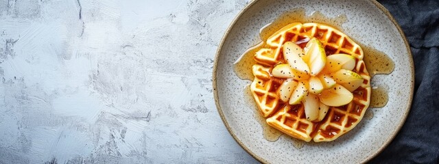 Canvas Print - Delicious waffle topped with sliced apples and drizzled with syrup on a textured plate with copy space for text