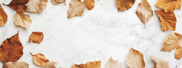 Canvas Print - Dried autumn leaves arranged around a blank marble background with Copy Space for text placement