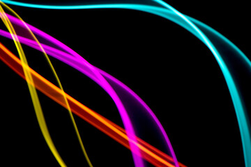 Neon Rainbow Light on Black Background Abstract Lines Swirls and Waves