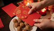 © Lightning - Hands Holding Red Envelope Chinese New Year