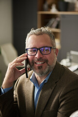 Poster - Smiling male boss of business firm with smartphone by ear organizing work in front of camera or making appointment with partner