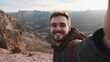 © Jess rodriguez - Happy young man on summer vacation taking a selfie waving at the camera on the top of a mountain