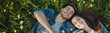 © carballo - smiling young couple lying on the grass in the field in spring