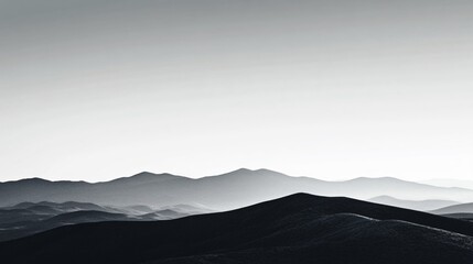 A grayscale landscape depicting a series of gentle mountain ridges gradually fading into a soft misty horizon, exuding tranquility and infinite calmness.