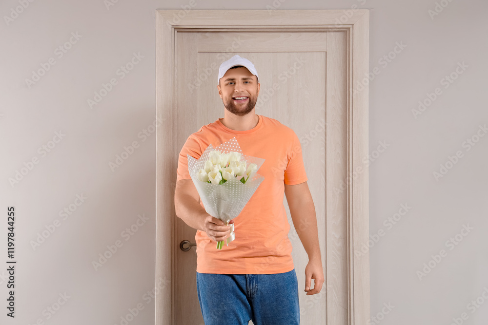 Male courier with flowers near door