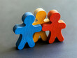 © PhotoArtHub - Wooden colorful puzzle figures symbolizing unity and teamwork
