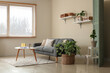 © Pixel-Shot - Interior of living room with black sofa, shelves, houseplant and table