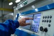© PICK YOUR POV - A hand interacting with a control panel in an industrial setting, showcasing technology and automation.