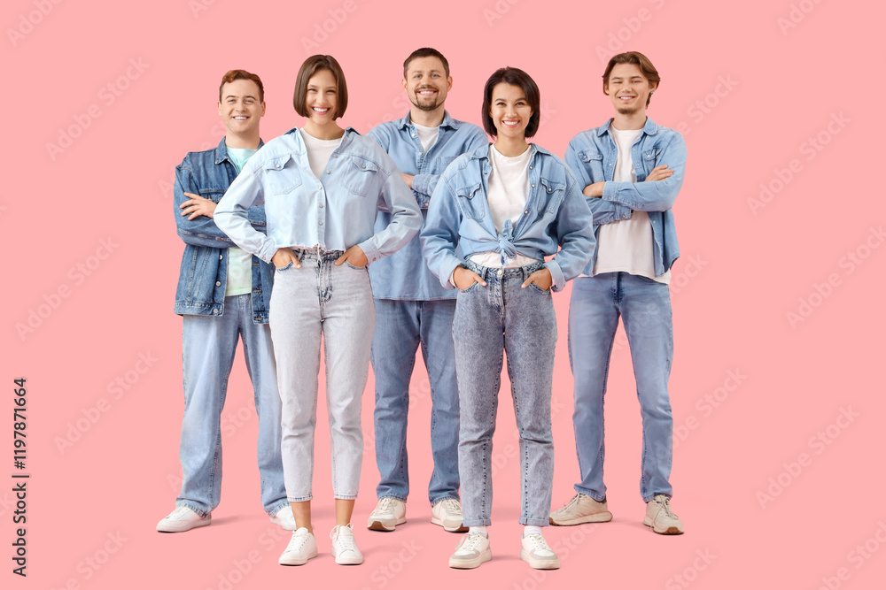 Group of young people in denim clothes on pink background