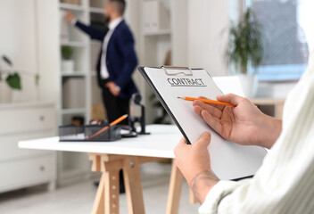 Wall Mural - Young man in wheelchair signing contract at lawyer's office, closeup