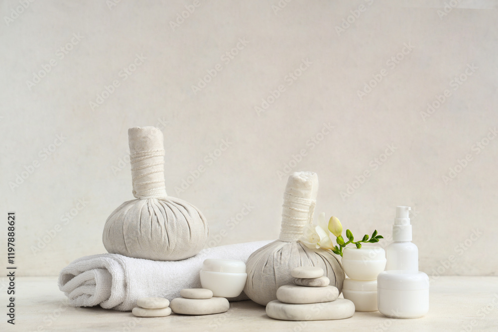 Different cosmetic products, spa accessories and freesia flower on light background