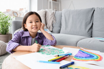 Wall Mural - Cute Asian girl drawing on table at home