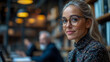 © sommersby - Portrait of a woman in glasses, working in a library setting
