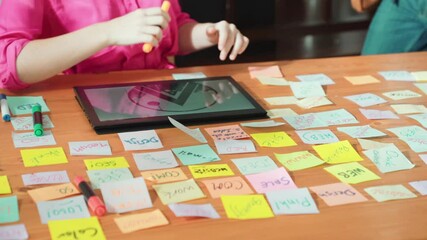 Sticker - Close up of project manager hands shaking hand with businessman at meeting table with sticky notes and tablet displayed logo design. Business team working together and talking about idea. Symposium.