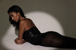 © face_reader_img - Beautiful young woman wears black top and trousers posing over white wall. Isolated.