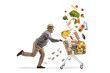 © Ljupco Smokovski - Full length shot of an elderly gentleman running with a shopping cart and falling groceries