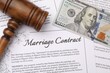 © New Africa - Marriage contract, gavel and dollar bill, top view