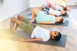 © JackF - Children doing glute bridge exercise, dvi pada pithasana pose, working out in yoga studio.