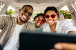 © Prostock-studio - African American Family Making Selfie In New Car On Smartphone. Happy Parents And Daughter Riding Car Enjoying Road Trip Traveling Together And Having Fun On Weekend. Selective Focus