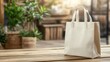 © pinporn manosri - A single reusable shopping bag with handles resting on a natural wooden table, perfect for showcasing text or logo placement.