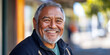 © VALUEINVESTOR - Portrait of a smiling senior Māori man in a New Zealand town street background, generative AI