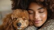 © aritha - Close-up of a young woman joyfully embracing her fluffy dog, showcasing a warm and intimate moment indoors