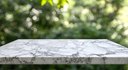 Wall Mural - white marble countertop on blurred green nature background.