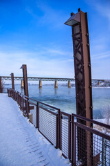 Wall Mural - A bridge spans a river with a railing on the side