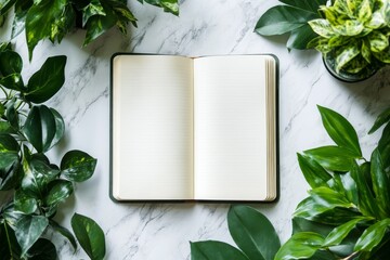 Wall Mural - a book is sitting on a table with a green leafy border around it. the book is open to a blank page, 
