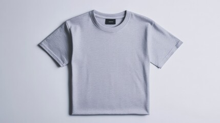 Wall Mural - a simple light gray t-shirt mockup folded on a white background