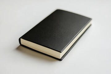Wall Mural - a black leather bound book with a white cover. the book is open to the middle of the page