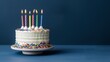 © Galib - A birthday cake with lit candles on a blue background.