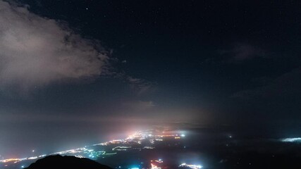 Wall Mural - bright coastal city lights and starry sky, time lapse