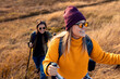 © Zoran Zeremski - Two smiling woman hiking at top of the hill at meadow.